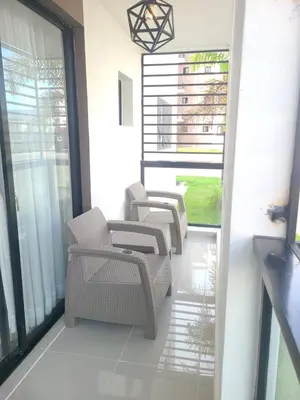 a balcony with chairs and tables on a building at Cama king, piscina 3 habitacines in Santiago de los Caballeros