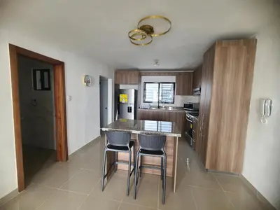a kitchen with a table and chairs in a room at Cama king, piscina 3 habitacines in Santiago de los Caballeros