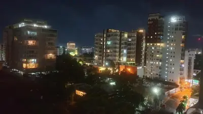 a city lit up at night with tall buildings at Encantador Apto en Torre de Lujo, Piscina, AC & Parking in Santo Domingo