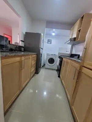 a kitchen with a refrigerator and a washer and dryer at Apartamento Amaya in Licey