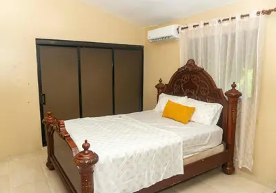 a bedroom with a bed with a wooden headboard at Casa de 2 Habitaciones in Los Frailes