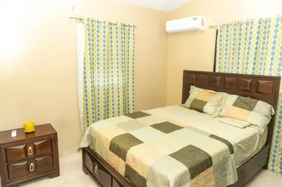 a small bedroom with a bed and a night stand at Casa de 2 Habitaciones in Los Frailes