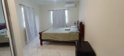 a bedroom with a bed in a room with a window at HEA Stays II in San Felipe de Puerto Plata