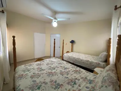 a bedroom with two beds and a ceiling fan at 2BR & 2 WR ocean view Suite at Villa Costa Verde in Playa Cofresi, Puerto Plata, with a pool, big veranda, and a rooftop terrace in San Felipe de Puerto Plata
