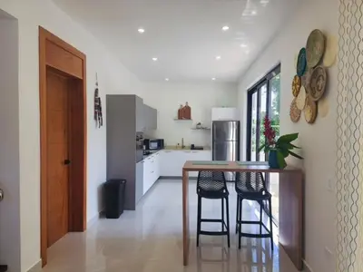 a kitchen with a table and some chairs in a room at Villas Montemar - Villa Mar in Las Terrenas