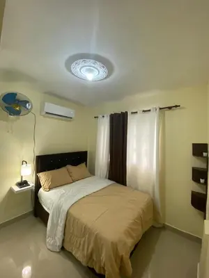 a bedroom with a bed with a light on the ceiling at Hogar lejos de casa, piscina in San Cristóbal