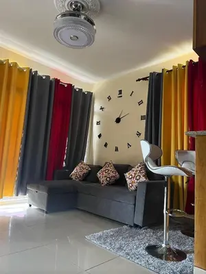 a room with a couch and a clock on the wall at Hogar lejos de casa, piscina in San Cristóbal