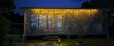 a fence with a light on it at night at BlueEcolandia Bungalow AGUA in Jarabacoa