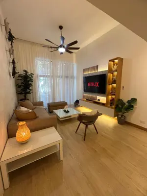 a living room with a couch and a tv at Aqua Loft 120 in La Puntica de Juan Dolio