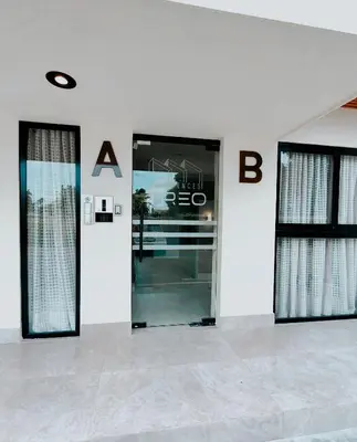 a building with two doors and a sign on the wall at Apartamento moderno 3H en TREO zona metropolitana in Santiago de los Caballeros