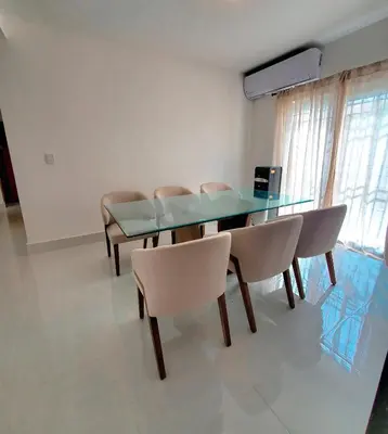 a dining room with a glass table and chairs at Apartamento moderno 3H en TREO zona metropolitana in Santiago de los Caballeros