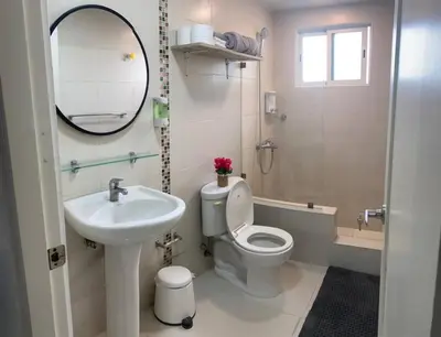 a bathroom with a sink and a toilet and a mirror at Luxury Ocean View Condo in Santo Domingo in La Francia