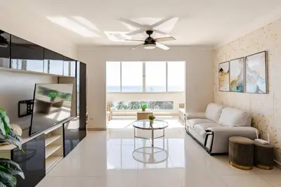a living room with a couch and a ceiling fan at Luxury Ocean View Condo in Santo Domingo in La Francia