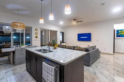 a kitchen and living room with a couch at Villa Ruby Bella in Sosúa