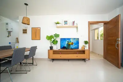 a dining room with a table and a wooden cabinet at CMB202 BEACH AREA Res Cristamar in Eslabón