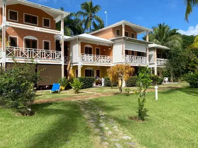 a large house with a yard in front of it at Appartement Paraiso 150m playa ballenas in Las Terrenas