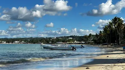two boats are docked on the shore of a beach at Casa Ballenas3 SF in Las Terrenas
