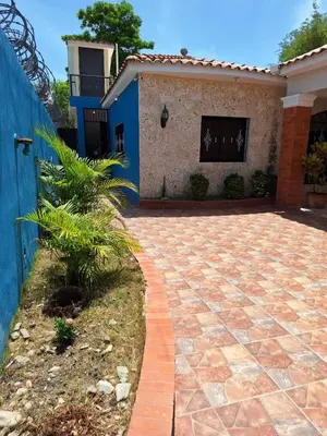 a brick driveway in front of a house at Casa Rural con Piscina in Azua de Compostela