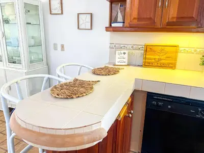 a kitchen with a counter with a table and chairs at Villa Cruz in Las Galeras