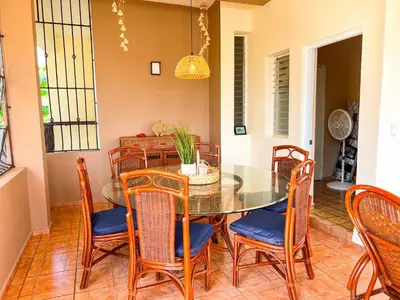 a dining room with a glass table and chairs at Villa Cruz in Las Galeras