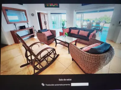 a living room with a couch and chairs and a table at Villa Los Corralillos in Cabrera