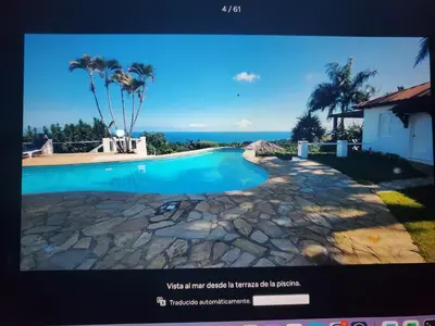 a tv screen with a picture of a swimming pool at Villa Los Corralillos in Cabrera