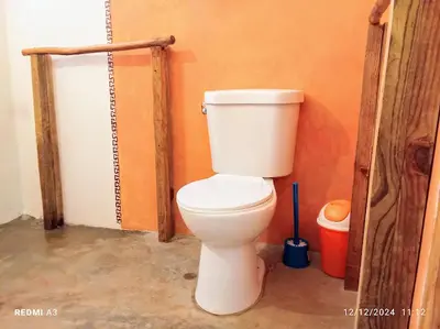 a bathroom with a white toilet in a room at Atabeba in Las Galeras