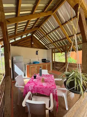 a room with a table and chairs and a kitchen at Atabeba in Las Galeras