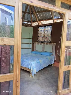 a bedroom with a bed in a wooden frame at Atabeba in Las Galeras