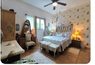 a bedroom with a bed and a chair and a table at Blue fish apartamento in Sosúa