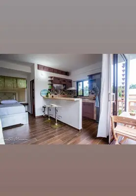 a living room with a kitchen and a bed at Casa Mariana in Las Terrenas