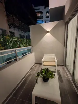 a balcony with a bench and a plant at Style and Confort Apart Villa Palmera in Santo Domingo
