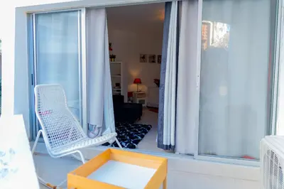 a room with a chair and a window at OCEANPARADISE to you ALBATRO l Y ll in Juan Dolio