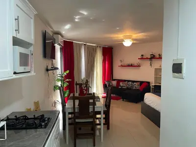 a small living room with a kitchen and a living room at OCEANPARADISE to you ALBATRO l Y ll in Juan Dolio