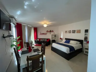 a bedroom with a bed and a dining room at OCEANPARADISE to you ALBATRO l Y ll in Juan Dolio