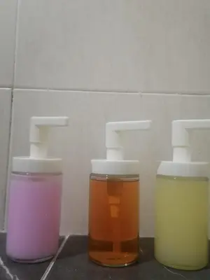 three jars of different colored liquids sitting on a counter at Fantastic with Terrace in the colonial zone in Santo Domingo