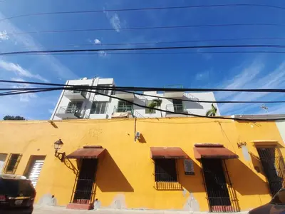a yellow building with windows on the side of it at Fantastic with Terrace in the colonial zone in Santo Domingo