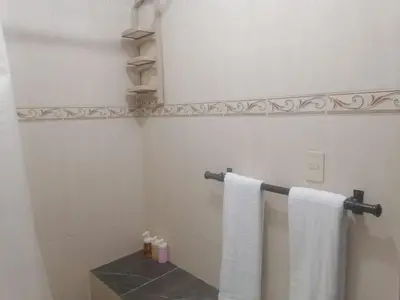 a bathroom with white towels hanging on a wall at Fantastic with Terrace in the colonial zone in Santo Domingo