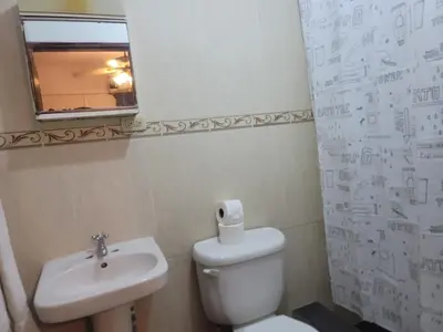 a bathroom with a toilet and a sink and a window at Fantastic with Terrace in the colonial zone in Santo Domingo