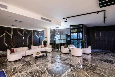 a living room with white couches and a table at lovera hotel in Santiago de los Caballeros