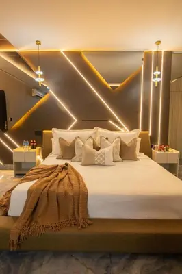 a bedroom with a large bed with lights on it at lovera hotel in Santiago de los Caballeros