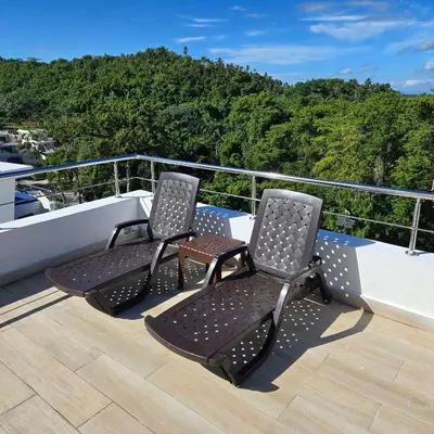 two chairs sitting on the deck of a ship at Las Terrenas Paradise in Las Terrenas