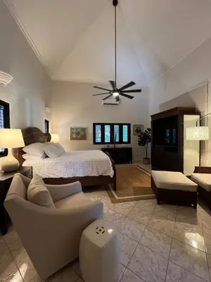 a large bedroom with a bed and a couch at Villa Marina in Sosúa