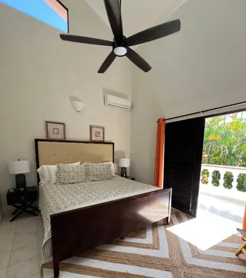 a bedroom with a bed and a ceiling fan at Villa Marina in Sosúa