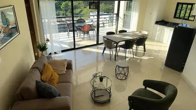 a living room with a couch and a table and chairs at Casa Vista Mar in Río San Juan
