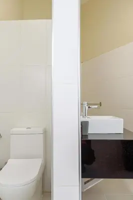 a bathroom with a white toilet and a sink at Casa Vista Mar in Río San Juan