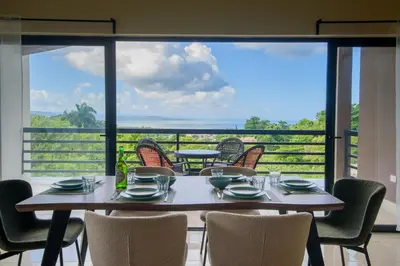 a table and chairs with a view of the ocean at Casa Vista Mar in Río San Juan