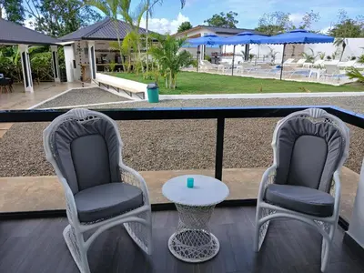 two chairs and a table on a balcony at aparthotel las taranas in Villa Riva