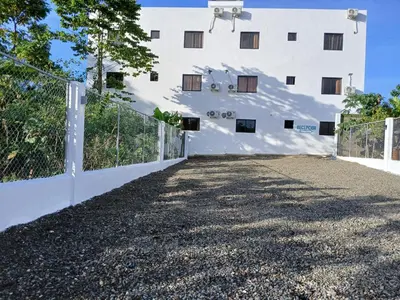 a fence in front of a white building at aparthotel las taranas in Villa Riva