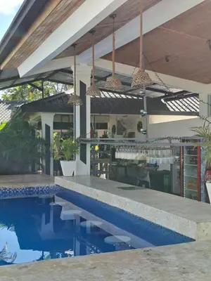 a house with a swimming pool in front of a house at aparthotel las taranas in Villa Riva